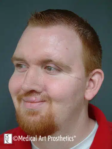 A man with red hair and beard wearing a red shirt.