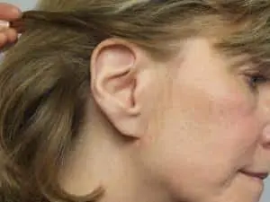 A woman with a large ear piercing.