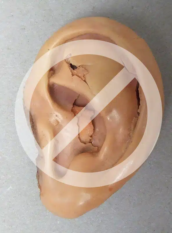 A picture of an ear with a no sign on it.