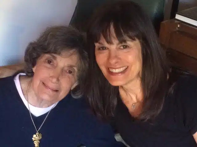 A woman and an older lady smiling for the camera.