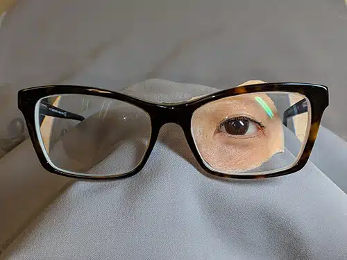 A person 's eye with glasses on top of them.