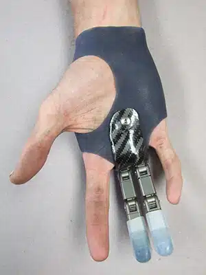 A person 's hand holding some tools in their fingers.