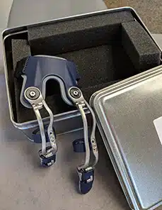A pair of blue headphones in a metal case.