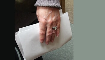 Partial Hand Prosthesis holding papers
